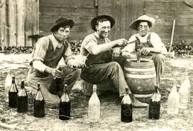 Men sitting around bottles of alcohol
